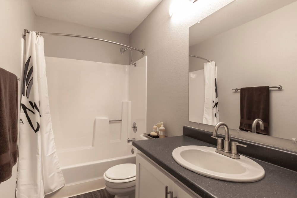 A renovated bathroom with a tub at Avery Park Apartments in Fairfield, California