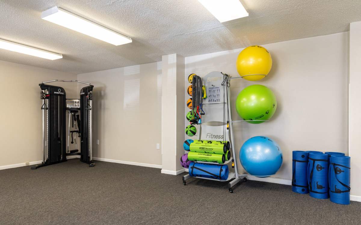 Fitness center with exercise ball and yoga mat at West Village Apartments in Hillsborough, North Carolina