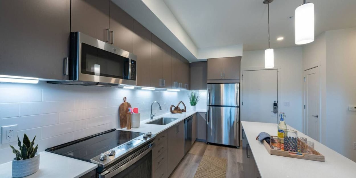 Modern kitchen with stainless-steel appliances at Copeland, Grand Prairie, Texas