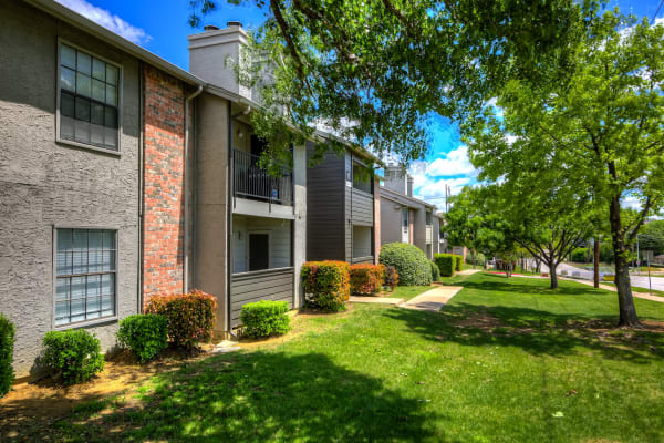 Grass and trees lining an apartment building at Canyon Grove in Grand Prairie, Texas