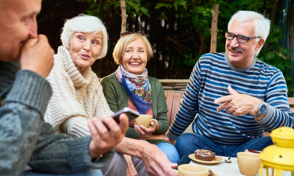 Residents sitting outside talking over breakfast at Randall Residence in Lawton, Michigan