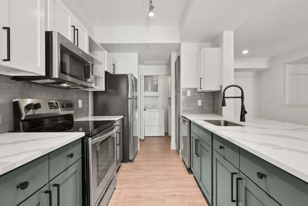 Bright kitchen with refrigerator at Vail Cliffside in Arlington. TX