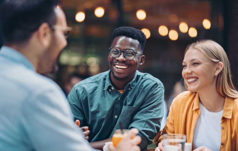 Friends enjoying drinks at a café near Balcones Trails in Kyle, Texas
