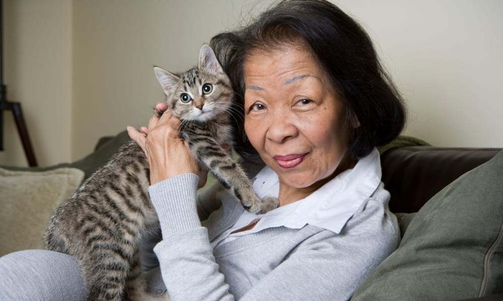A photo of a woman holding a cat at Brookdale Cedar Ridge.
