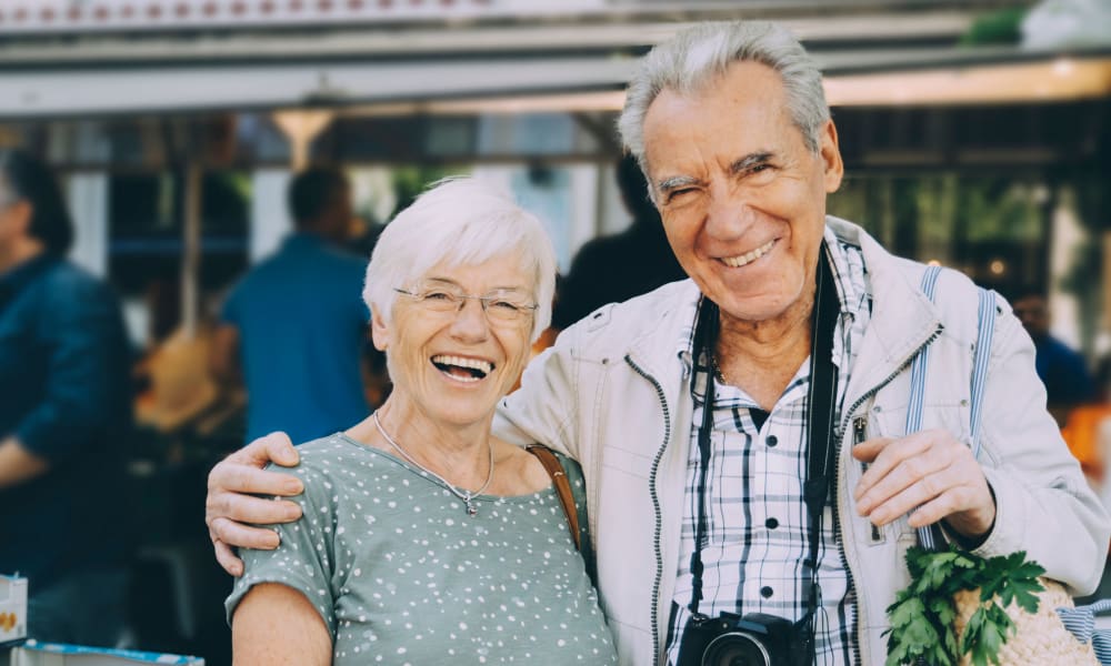 Happy resident couple on a day trip to the city near their home at a community by Cascade Senior Living Services