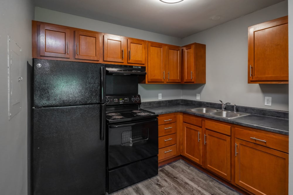 Kitchen with black appliances at Gibson Creek Apartments in Madison, Tennessee
