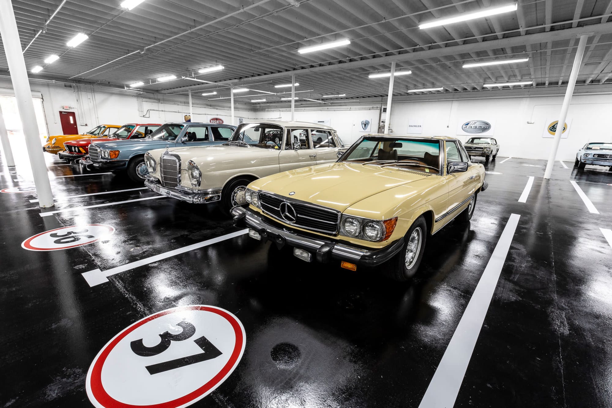 A Mercedes in front of a row of luxury cars inside the secure garage of Premier Car Storage