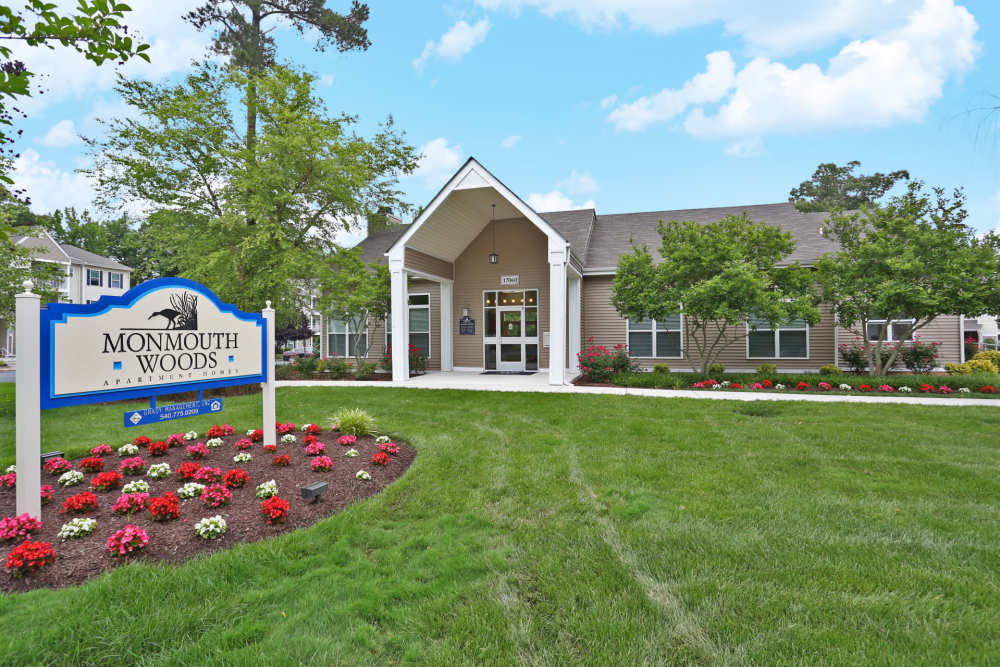 Property signage board with view of apartment at Monmouth Woods in King George. VA