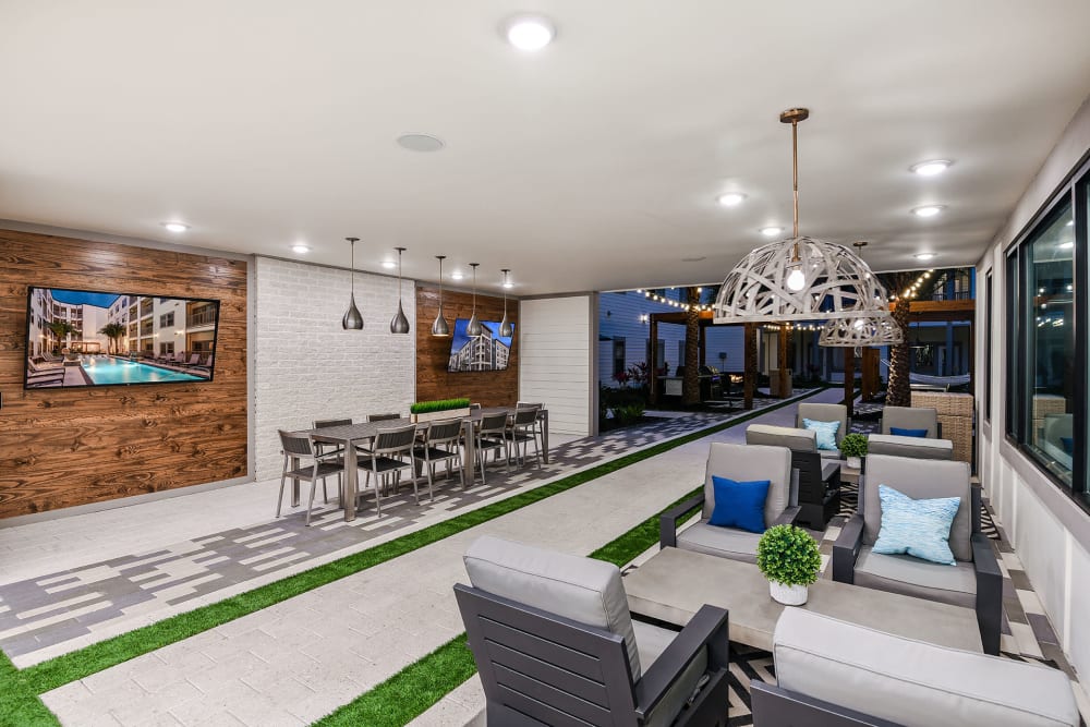 Resident recreation area with multiple tvs and couches at Soba Apartments in Jacksonville, Florida