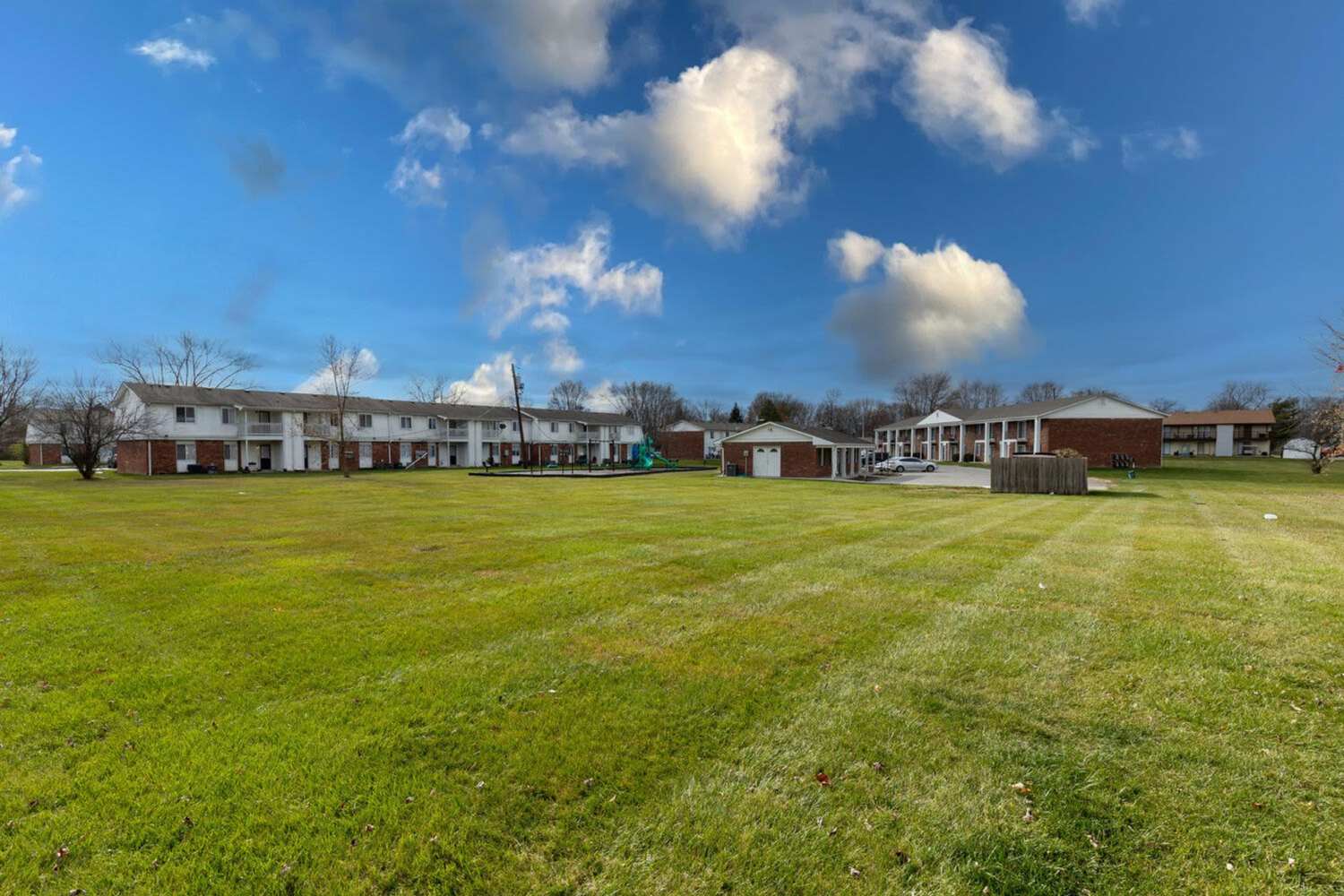 Community exterior with green lawn at Cumberland Manor in Indianapolis, Indiana