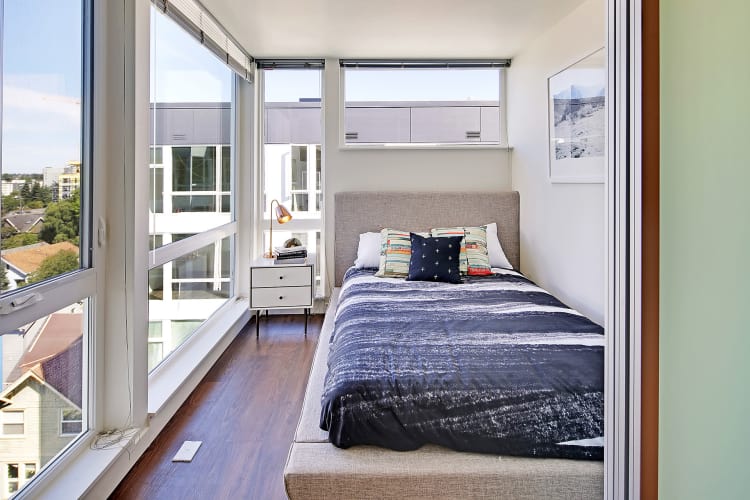 Large bedroom windows in the bedroom at Rooster Apartments in Seattle, WA