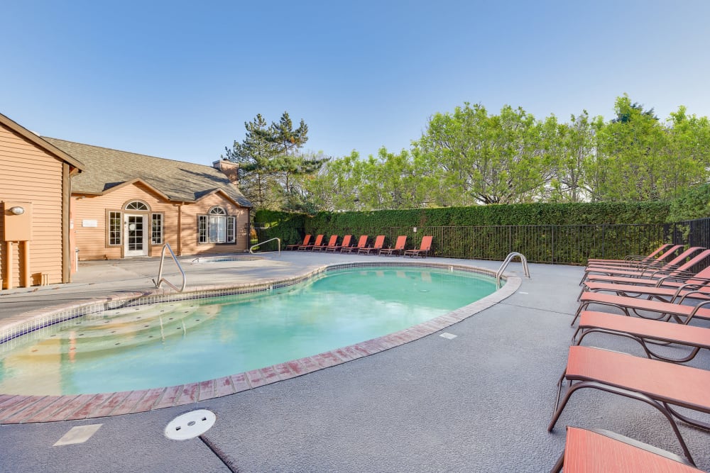 Resort-style swimming pool with lounge chairs at Renaissance at 29th Apartments in Vancouver, Washington