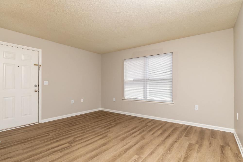 Unfurnished living room with wood-style flooring at West Village Apartments in Hillsborough, North Carolina
