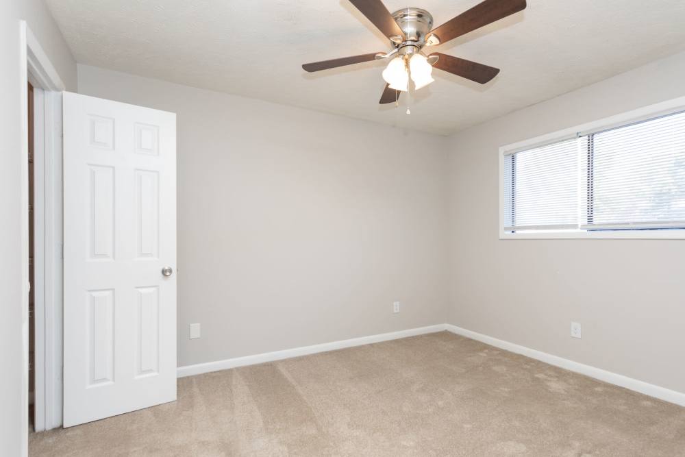 Unfurnished bedroom with window and carpet flooring at Landmark Flats in Fayetteville, North Carolina