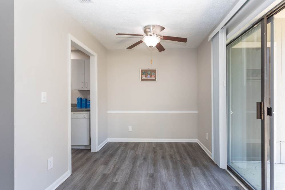 Dining area with ceiling fan and hard wood flooring at Landmark Flats in Fayetteville, North Carolina