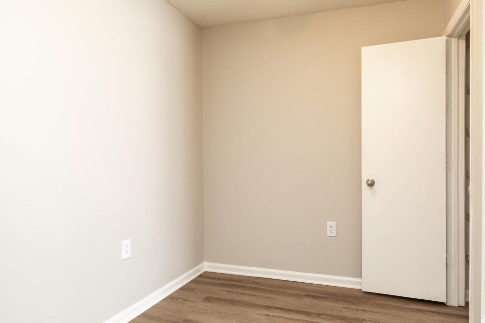 Unfurnished bedroom with wood flooring at West Village Apartments in Hillsborough, North Carolina