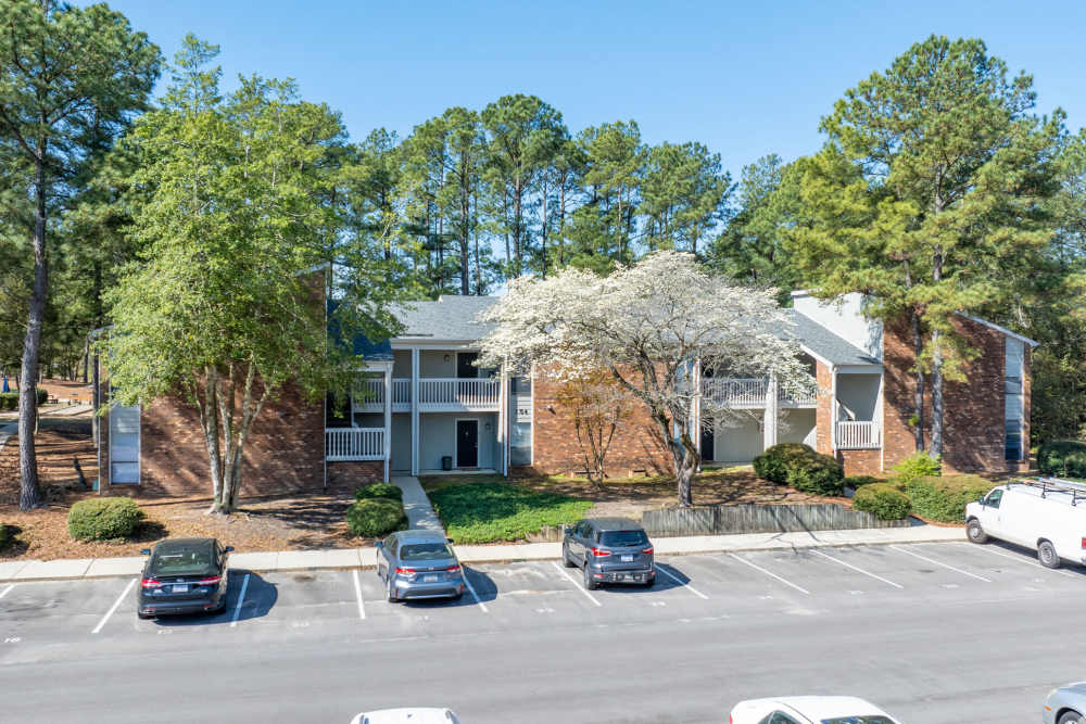 Exterior view of the apartment community with parking at Landmark Flats in Fayetteville, North Carolina