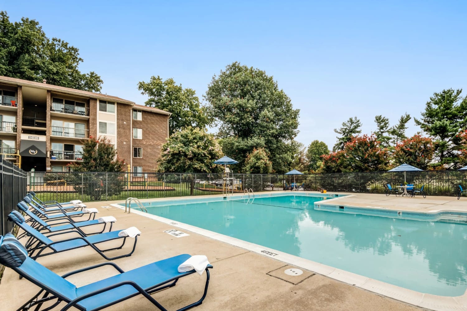 Swimming pool and sundeck lounge chairs at Montgomery Trace Apartment Homes in Silver Spring, Maryland