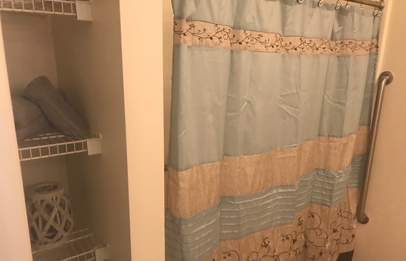Resident bathroom with a shower curtain at Arcadian Cove in Richmond, Kentucky.