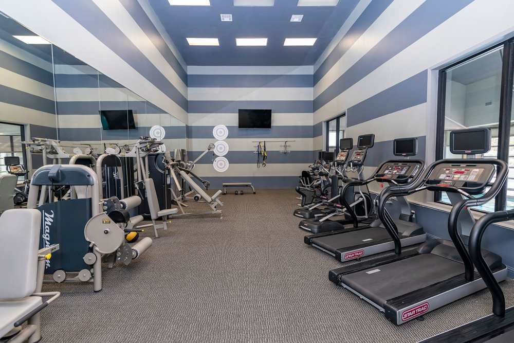 Fitness center with treadmills at Halston in Dallas, Texas