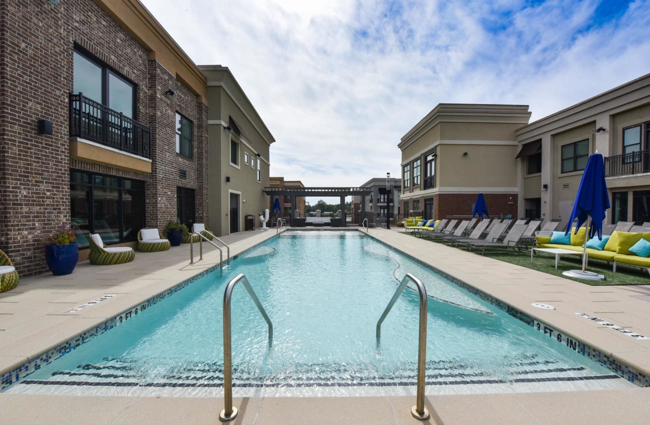 2-BR Apartments in Alpharetta, GA -The Haven at Avalon - Modern Plunge Pool & Lounge Ledges surrounded by Patio Furniture.