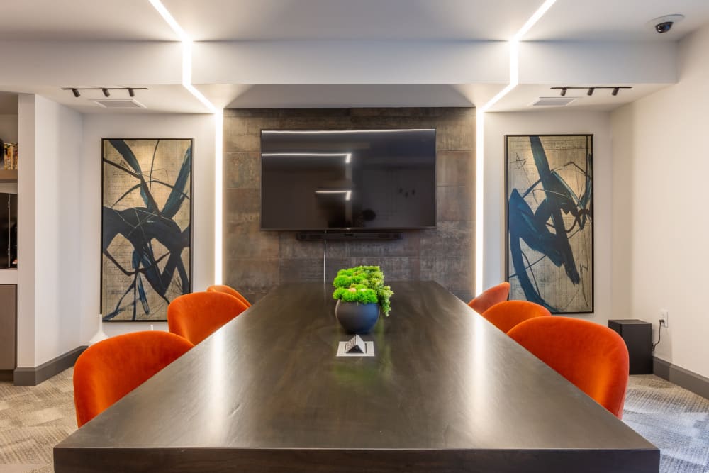 Conference room with a large flatscreen TV for resident use at ArLo Apartments in Portland, Oregon