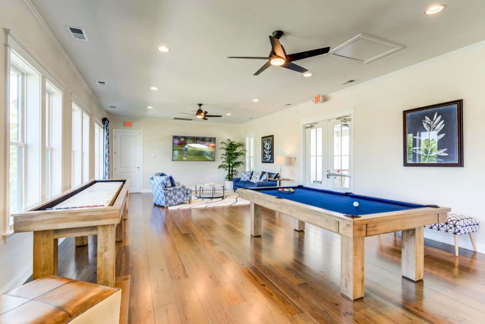 Community clubhouse lounge with games at Seaglass Cottage in North Myrtle Beach, South Carolina