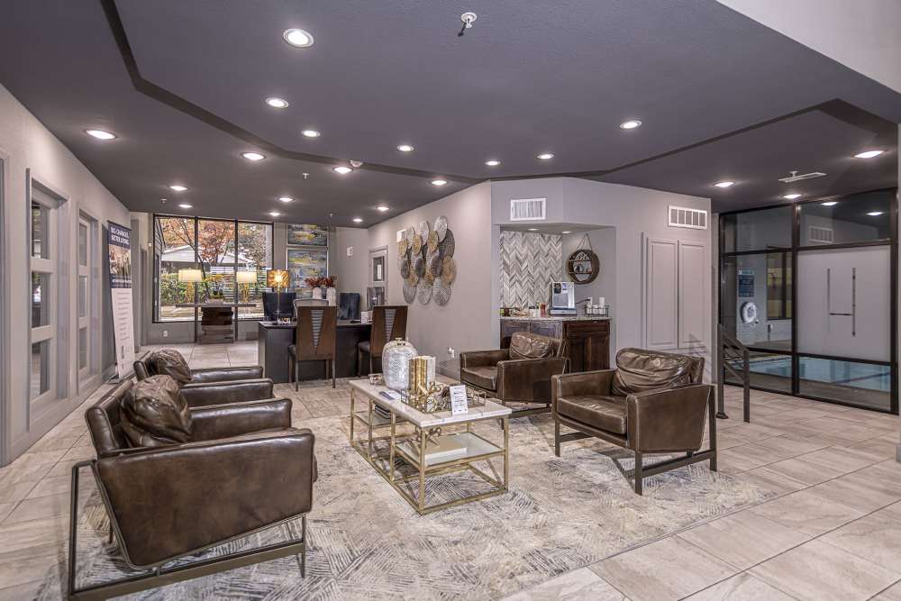 Clubhouse with lounge seating and tile flooring at Halston in Dallas, Texas