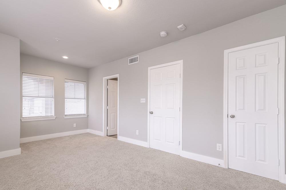 Bedroom with windows at Slate at Cole in Dallas, Texas