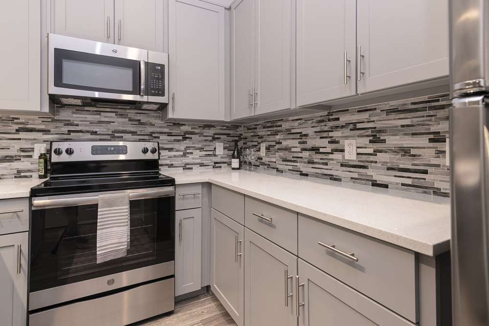 Kitchen with white cabinetries at Slate at Cole in Dallas, Texas