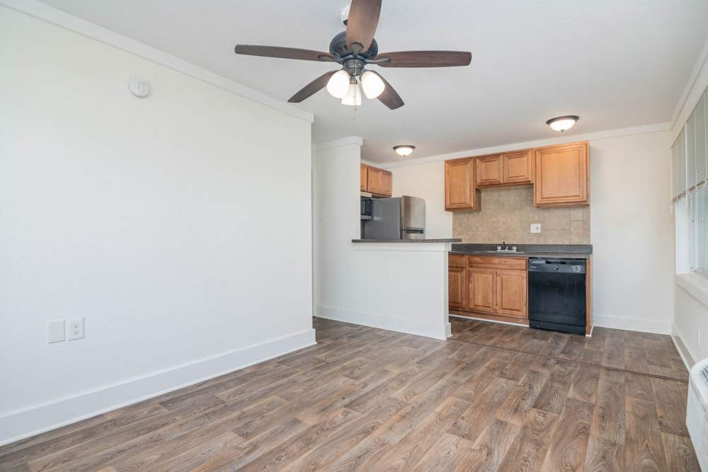 Living room with access to kitchen with hard wood flooring at Ocean View Living in Norfolk, Virginia