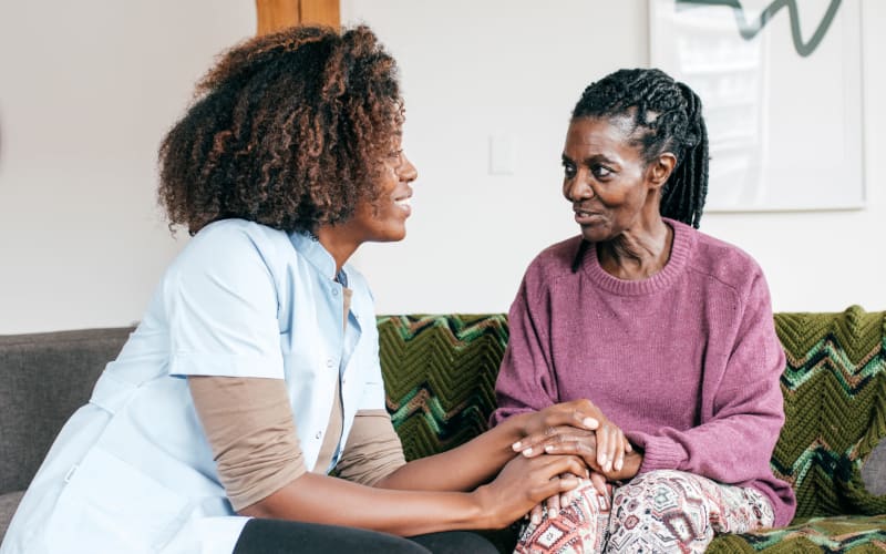 Staff member talking with a resident at Grand Villa of Altamonte Springs in Altamonte Springs, Florida