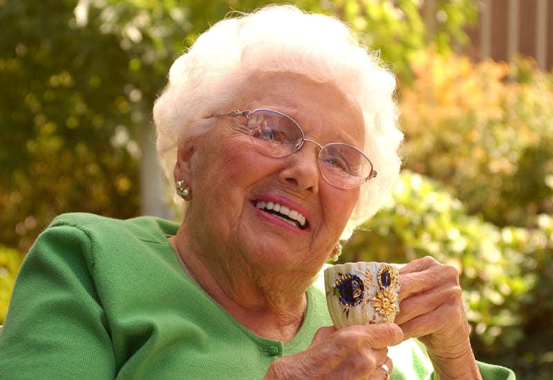 Woman with a teacup at Carefield Living. 