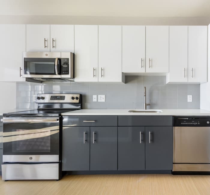 Kitchen with hardwood floors and stainless-steel appliances at The National in Philadelphia, Pennsylvania
