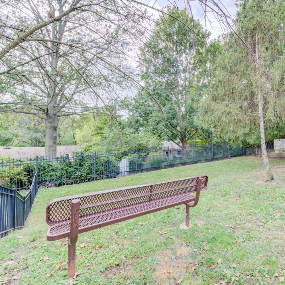 Lush greenery and peaceful seating area at a charming property in Maryland Heights, Missouri.