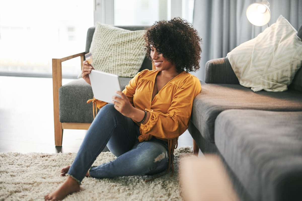 A resident relaxes on the floor in her apartment at Icon on The Greenway, Gastonia, North Carolina