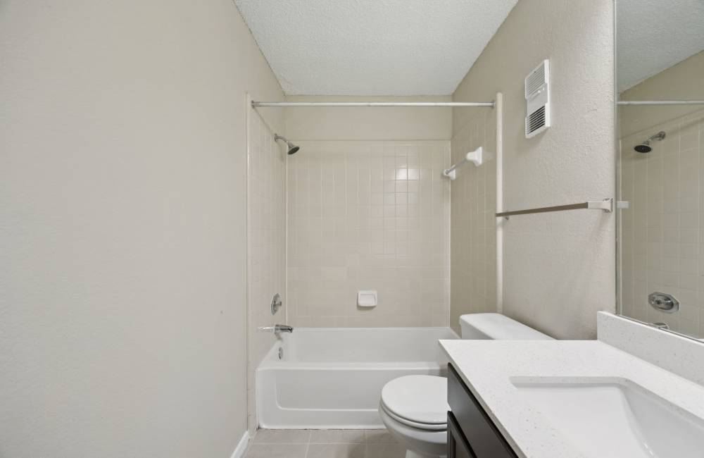 A spacious bathroom at Shadow Brook Apartments in Arlington, Texas