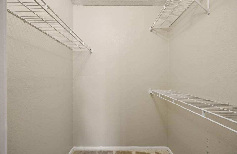 A walk-in closet at Shadow Brook Apartments in Arlington, Texas