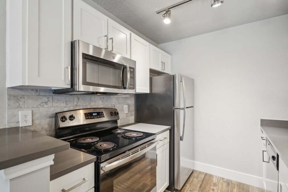 Kitchen with white cabinet at Halston in Dallas, Texas