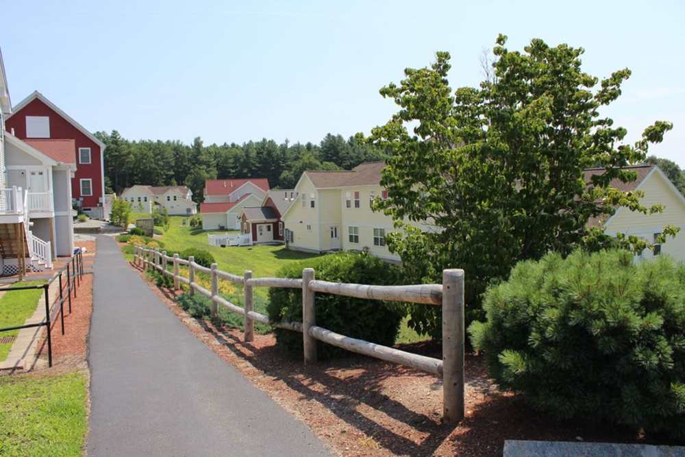 Scenic path with homes and greenery near Stony Brook Village in Westford, Massachusetts