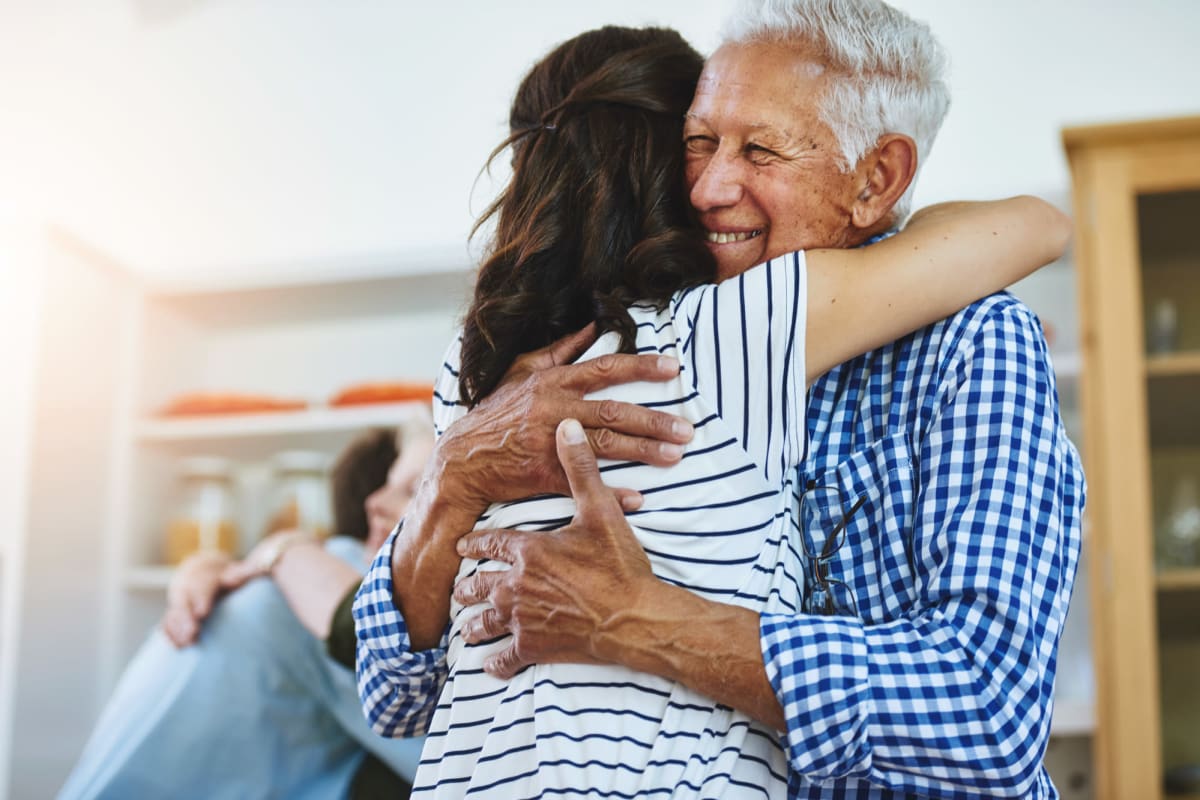 Resident hugging a younger person at The Bellettini in Bellevue, Washington