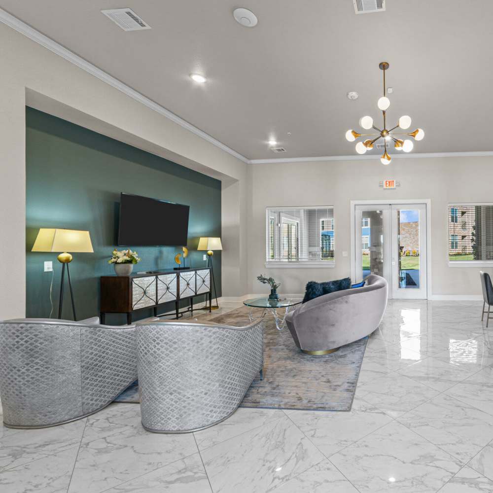 Community living area with flat-screen TV at Brook Hollow in Wichita Falls, Texas