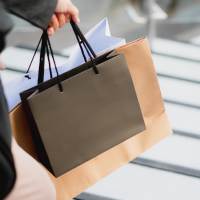 Resident walking in the neighborhood with shopping bags near Seacrest in Katy, Texas