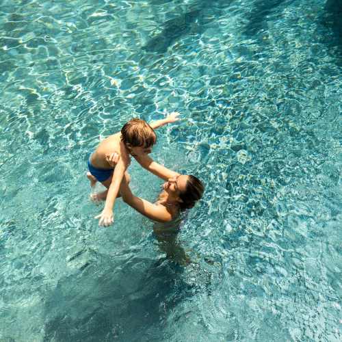 Kid and her mother playing in a pool at Afton Palms in Sanford, Florida