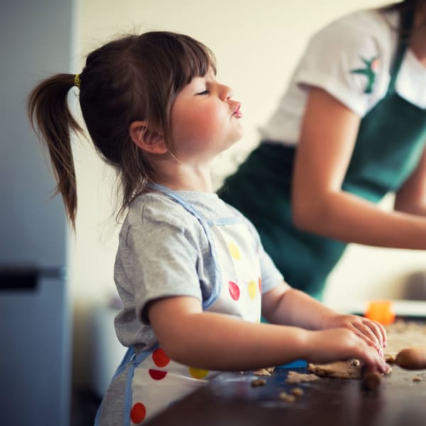 A kid helping he mother in kitchen at Symphony Property Management in Buffalo, New York