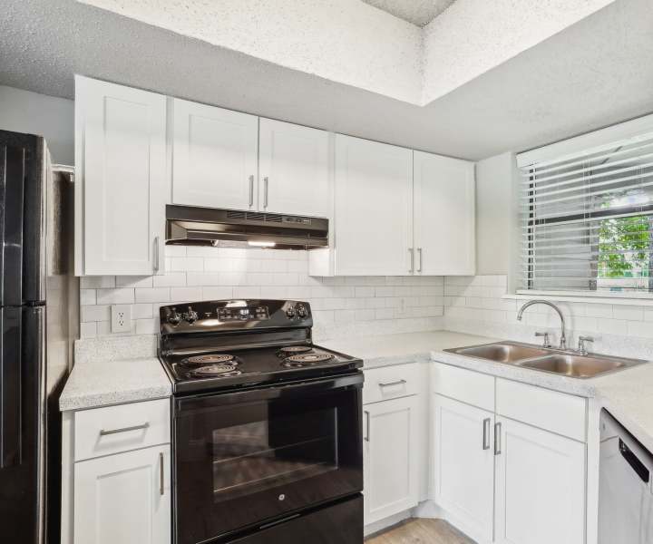 Kitchen with quartz countertops and appliances at Vantage Point Apartments in Dallas, Texas