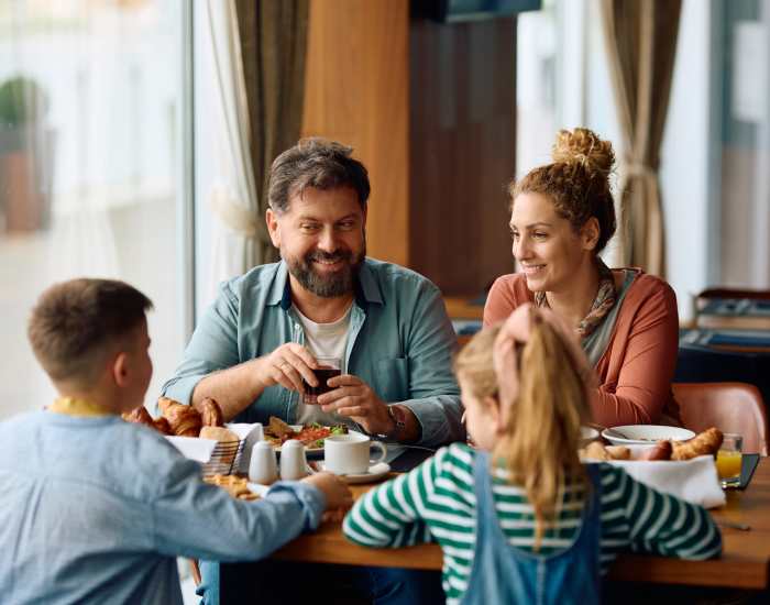 Happy resident family dining in the restaurant near Fountain Terrace in New Brighton, Minnesota