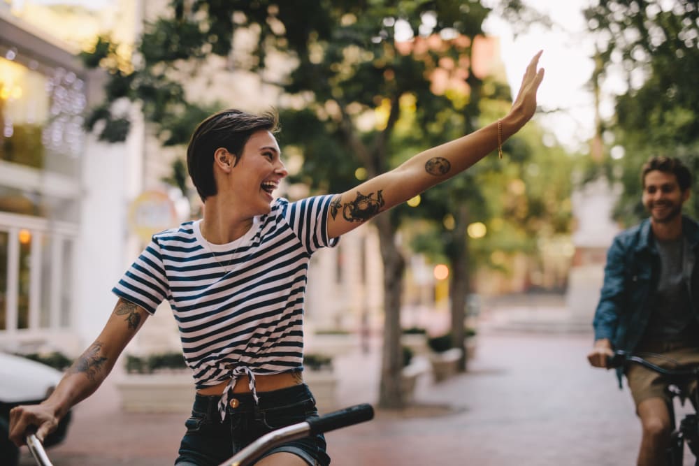 Residents riding bikes and saying hello at Crescent House Apartments in Miami Lakes, Florida