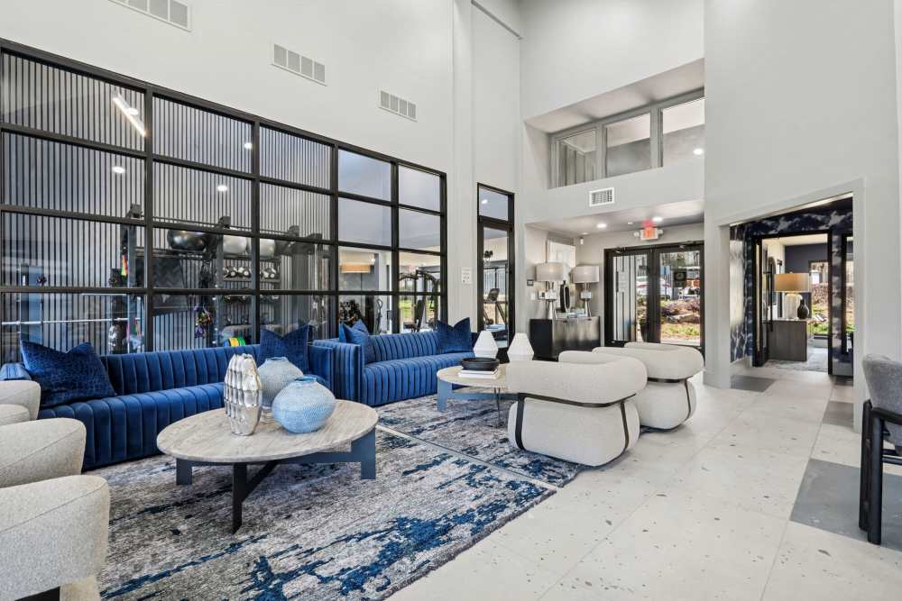 Community clubhouse with large couch, chairs and coffee table at Stillwater in Charlotte, North Carolina
