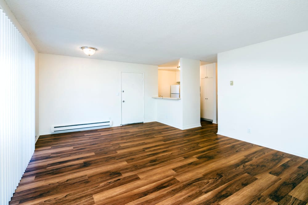 Spacious living room with hardwood style flooring at Bidwell Park Fremont in Fremont, California